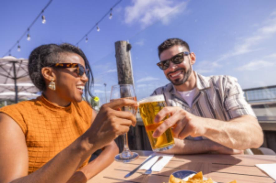 couple enjoying wine and beer at Half Moon Bay Brewing Company's outdoor dining patio