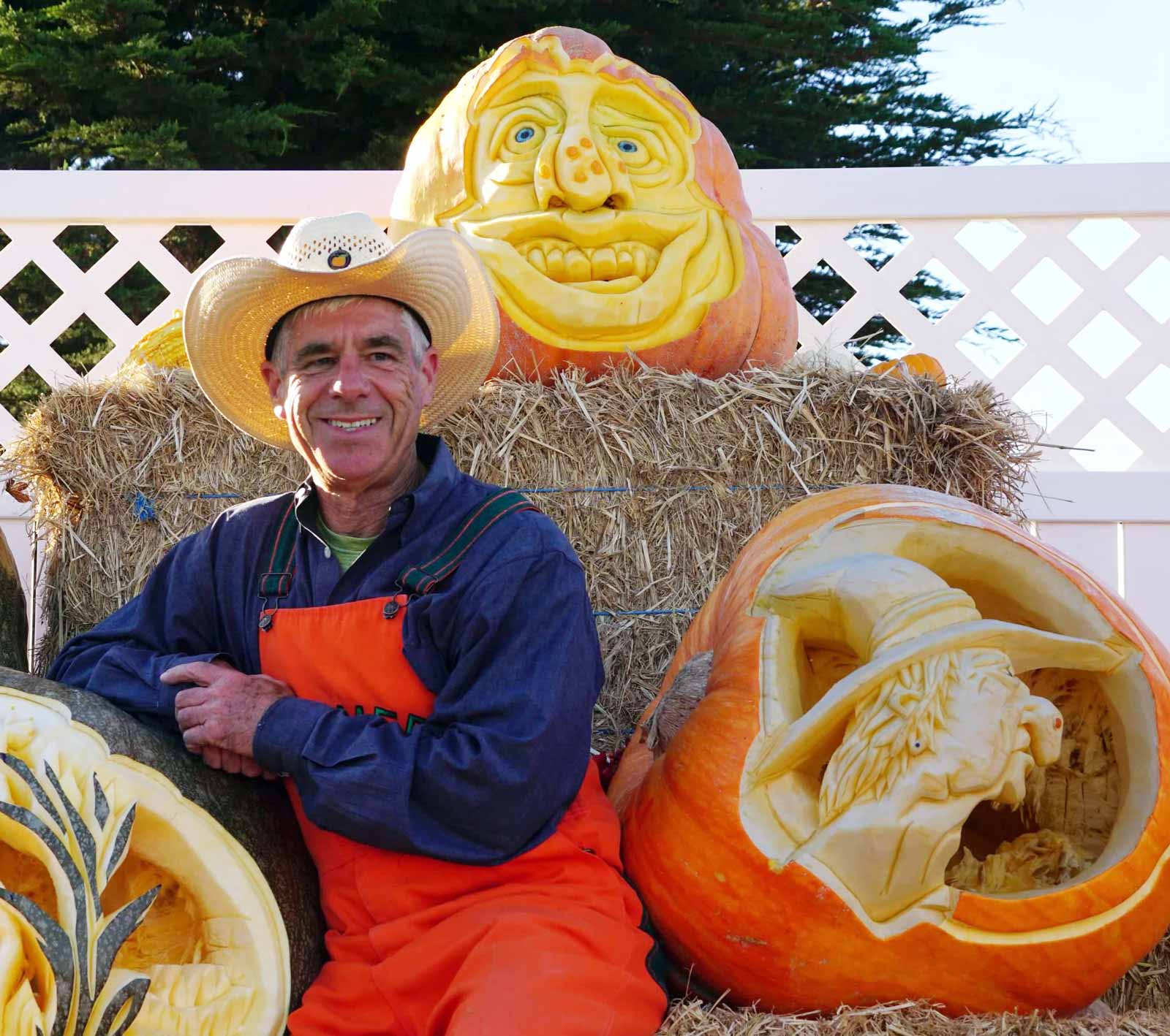 Farmer Mike poses with his 50th anniversary Pumpkin Festival 3-tier carved pumpkin water feature
